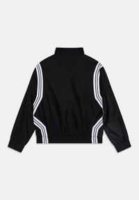 Black athletic jacket featuring a high collar, elastic waistband, and white diagonal stripes along the sides. Smooth, lightweight material.