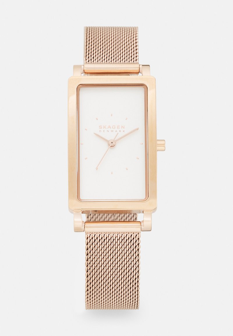 Rechteckige roségoldene Uhr mit einem weißen Zifferblatt. Sie verfügt über ein Mesh-Band und ein minimalistisches Design mit Stundenmarkierungen und subtiler Markenkennzeichnung.