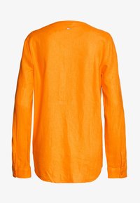 Lange mouwen shirt in helder oranje linnen, met een ronde halslijn, met knopen afgewerkte manchetten en een rechte zoom met een klein logo-etiket aan de achterkant.