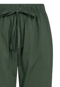Green textured pants with an elastic waistband and a tied drawstring detail, featuring a lightweight, breathable fabric.