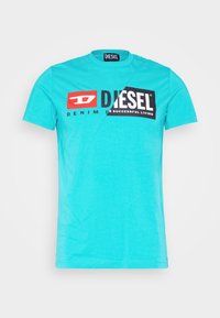 Turquoise T-shirt made of cotton featuring a round neck, short sleeves, and bold black and red branding across the front.
