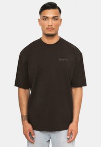 Black oversized t-shirt made from cotton, featuring short sleeves and a round neckline. Text “Dropsize” in light embroidery on the chest.