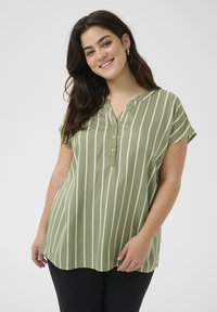 Blouse rayée verte en tissu léger, dot�ée d'un col en V, de manches courtes et d'une fermeture à boutons sur le devant avec un ourlet incurvé.