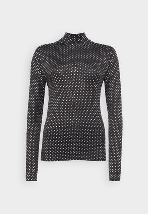 Black long-sleeve turtleneck top featuring a polka dot pattern in white, made from a smooth, stretchable material. Close-fitting design.