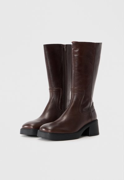 Brown leather knee-high boots with a smooth texture, featuring a side zipper and a chunky heel for stability.