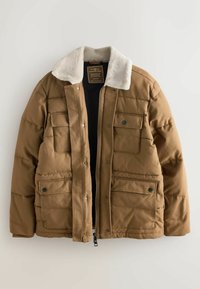 Pruun pehme voodriga jakk, millel on karusnaha krae, kaks eesmist taskut, nööbiga kinnitused ja tõmblukk. Lihtne disain pehme tekstuuriga.