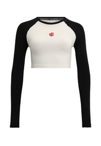 Black and white cropped long-sleeve top, featuring a white body, black sleeves, and a red logo on the chest. Soft cotton material.