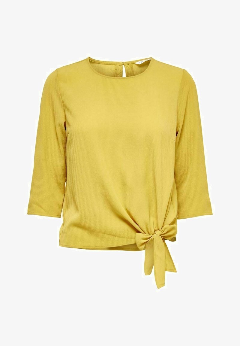 Blouse jaune à manches trois-quarts avec col rond et nœud décoratif sur le côté à la taille.