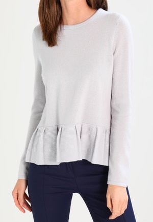 Light gray long-sleeve sweater with a ribbed peplum hem. Made of a soft fabric, features a rounded neckline, and textured lower section.