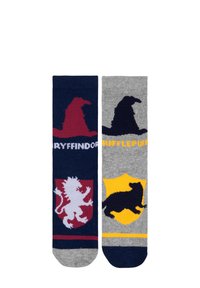 Calze di Gryffindor e Hufflepuff; lavorate a maglia in blu navy e grigio con i simboli delle case: leone, tasso e cappello smistatore in colori a contrasto.