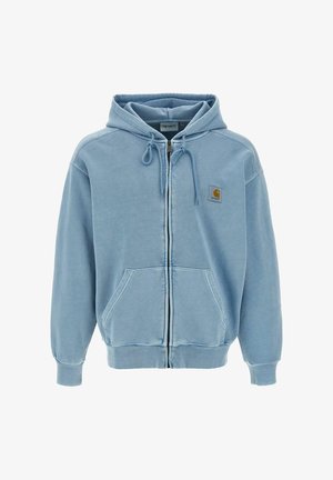 Jasnoniebieska bluza z kapturem i zamkiem błyskawicznym, z trokami w kapturze, kieszeniami na przodzie i małym logo Carhartt na lewym piersi.