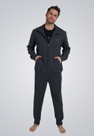 Dark gray zip-up jacket with side pockets and matching sweatpants, made of soft fabric, featuring a logo on the chest and a relaxed fit.