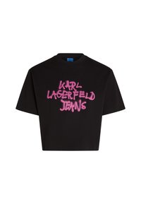 Černé zkrácené tričko z bavlny s výrazným růžovým sprejem napsaným "KARL LAGERFELD JEANS" na přední straně. Krátké rukávy a kulatý výstřih.