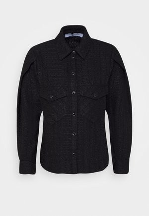 Black textured long-sleeve shirt with pointed collar, snap buttons down front, and two flap chest pockets with snap closures.