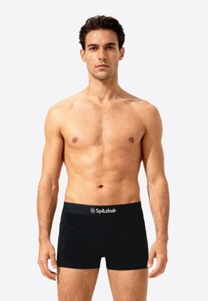 Black boxer briefs featured with a branded waistband, made from a smooth, stretchy material, showcasing a fitted design and mid-rise shape.