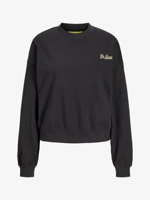 Czarna, długorękawowa krótka bluza z okrągłym dekoltem i małym beżowym logo „La Siesta” na górnej lewej części klatki piersiowej.