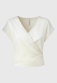 Kremowa lniana bluzka z krótkimi rękawami, z dekoltem w kształcie litery V i fakturowanym wykończeniem. Prosty, czysty design bez widocznych elementów metalowych.