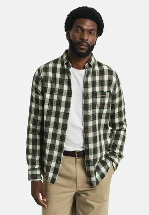 Geruite flanellen shirt in groen en wit met accenten in rood en blauw. Voorzien van een knoopsluiting aan de voorkant, een kraag en een borstzak. Lichtgewicht materiaal.