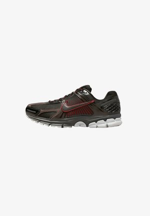 Black and gray running shoe with mesh material, red accents, textured detailing, and a cushioned sole featuring a white midsole.