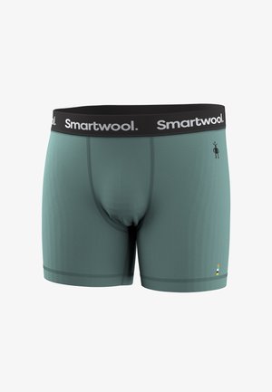 Miesten sinivihreät bokserit, joissa on musta vyötärönauha ja valkoinen "Smartwool"-logo sekä pieni musta ihmisfiguuri oikean puolen etuosassa.