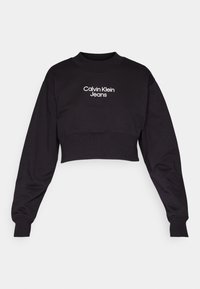 Svart kortärmad sweatshirt med långa ärmar, med ribbad krage och cuffs. "Calvin Klein Jeans"-logotyp i vitt på framsidan.