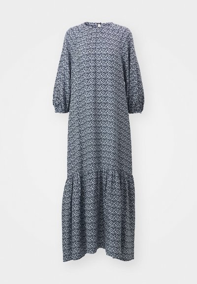 Granatowa sukienka z długim rękawem, wykonana z materiału w wzory, z okrągłym dekoltem i warstwowym, falbaniastym dołem. Uszyta z lekkiego materiału.