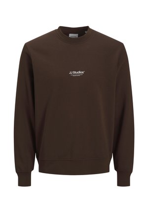 Brązowa bluza z okrągłym dekoltem i długimi rękawami. Posiada białe logo „JJ Studios” na piersi. Wykonana z miękkiego, strukturalnego materiału.