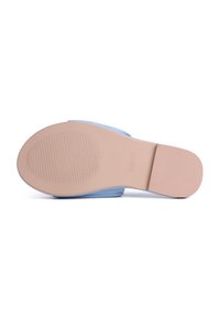 Blue slip-on shoe with a smooth upper and a light tan rubber sole featuring ridged texture and a rounded toe design.