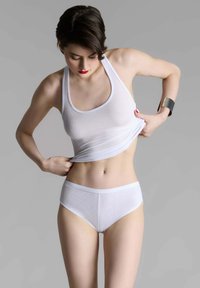 White ribbed tank top and high-waisted panties, both made of lightweight fabric. Braided hair and red lipstick accent the look.