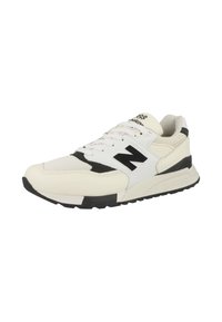 White and black athletic shoe with mesh and leather materials, prominent 'N' logo, textured sole, and padded collar.