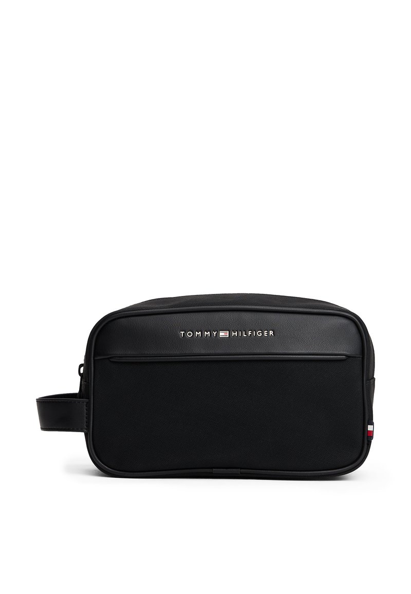 Black toiletry bag with a smooth leather finish, featuring a front zip pocket, embossed logo, and a side handle for easy carrying.