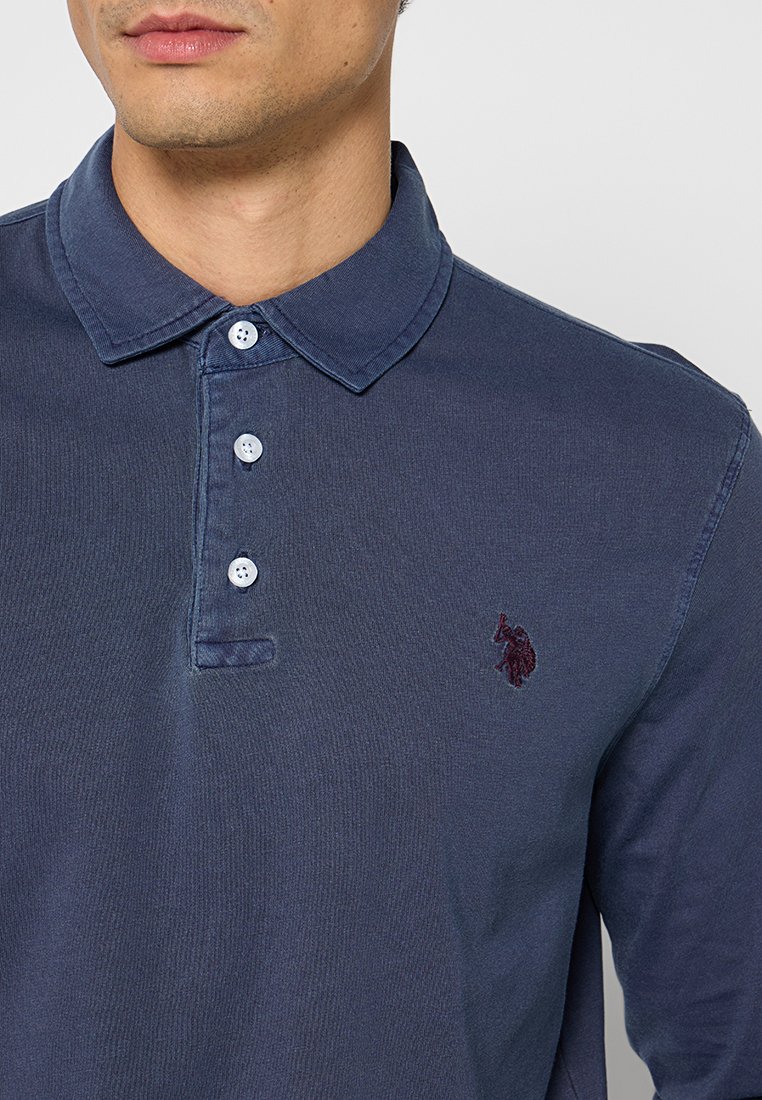 Marineblaues Langarm-Polohemd aus Baumwolle, mit einem gerippten Kragen, einer Knopfleiste mit drei Knöpfen und einem gestickten Logo auf der linken Brust.
