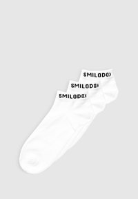 Drei Paar weiße Knöchelsocken aus Baumwolle mit schwarzer "SMILODON"-Markierung an den Bündchen, mit glatter Textur.