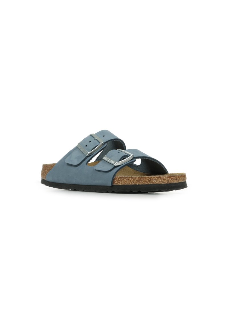 Blue leather slide sandal with two adjustable buckles, cork footbed, and textured black rubber sole. Simple design for comfort and support.
