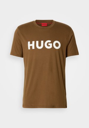 Brown short-sleeve t-shirt with "HUGO" in bold white letters across the chest and a red interior label.