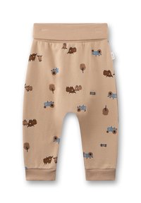 Beige Jersey-Hosen mit einem elastischen Bund, die ein Muster aus braunen Bisons, blauen Traktoren und braunen Bäumen aufweisen, mit umgeschlagenen Knöcheln.