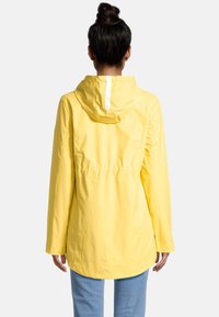 Yellow rain jacket with a hood, featuring a cinched waist, long sleeves, and a smooth, water-resistant texture. Back view shows minimal design.