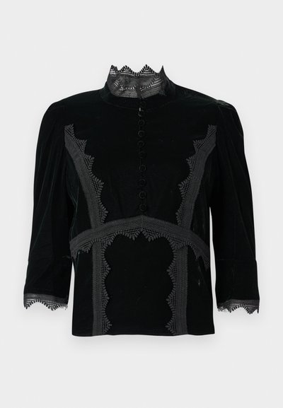 Svart fløyelsbluse med høy kant, intrikate blonder, åtte dekorative knapper og ermer til albuen.