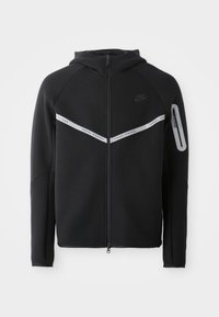 Sweatshirt preto com fecho de correr, apresentando uma faixa refletora no peito, capuz ajustável e um bolso lateral com fecho de zipper.