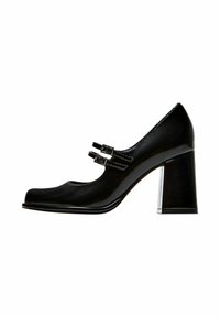 Black patent leather high-heeled shoe with a rounded toe, double buckle accents, and a chunky heel. Smooth surface with shiny finish.