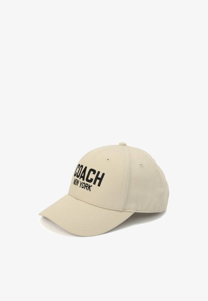 Beige baseballkeps i bomullsblandning, med svart broderad text "COACH NEW YORK", med en böjd skärm och justerbart nackband.