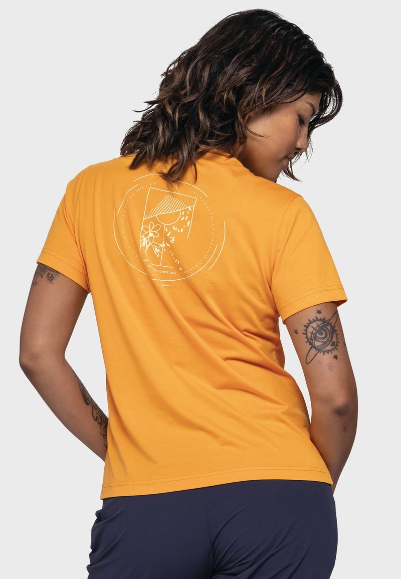 Orange Baumwoll-T-Shirt mit kurzen Ärmeln. Auf der Rückseite befindet sich ein weißes grafisches Design, das eine Blume in einem kreisförmigen Rahmen darstellt.