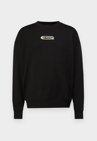 Μαύρο φούτερ με στρογγυλή λαιμόκοψη και ριγμένα μανίκια. Διαθέτει το λογότυπο G-STAR σε αντίθεση μπεζ στο ύψος του στήθους. Ριμπ μανσέτες.