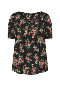 Svart blommig blus med korta puffärmar, en rynkad halsringning med en knytning och ett botaniskt tryck i röda och gröna nyanser.