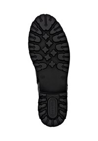 Semelle de chaussure noire avec un design texturé et robuste, comportant de profonds sillons et motifs. Les marquages incluent des informations de taille et le logo de la marque.