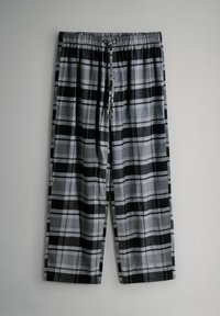 Czarno-białe i szare piżamowe spodnie z wzorem w kratę, z sznurkiem do ściągania i elastycznym pasem, pokazane na płasko na jasnym tle.