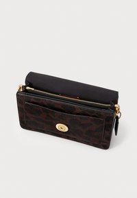 Leopard print wallet made of textured, fur-like material with a gold-tone magnetic snap closure and a black fabric interior featuring a zipper.