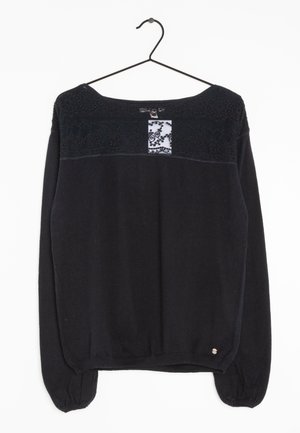 Černý svetr s dlouhým rukávem, s texturovaným krajkovým detailem a malým bílým panelem na prsou. Elastické manžety a spodní lem. Měkká tkanina.