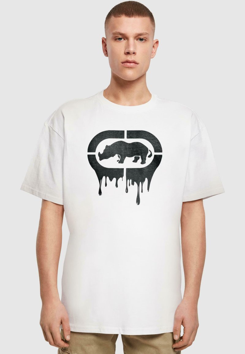 Hvid bomulds T-shirt med et sort grafik af en næsehorn med dryppende maleffekter, rund halsudskæring og korte ærmer.