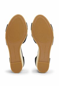 Black fabric sandals with a woven espadrille midsole and rubber outsole. Features include a textured sole and branding on the insole.